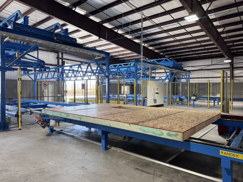 A wall panel moving into the robotic station for bundle assembly. This is the last step prior to staging for shipment from FrameTec’s plant. Credit: FrameTec