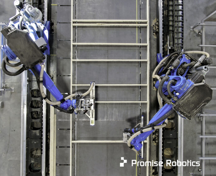 Two Promise robots work together to build a wall.