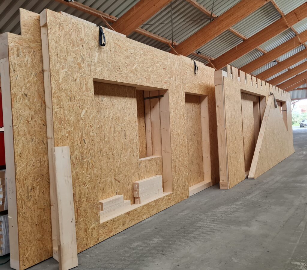 These wall panels and associated components for a residential housing project were 100% fabricated by robots. Note the lifting straps, which were also installed by the robots.