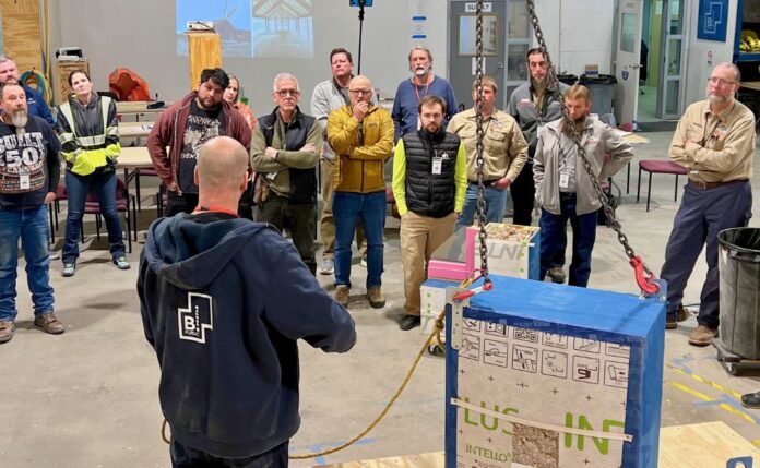 Day 1 in the “classroom” in B.Public’s R&D Shop. CTO Jonah Stanford explains rigging with a small sample panel. Courtesy B.Public Prefab