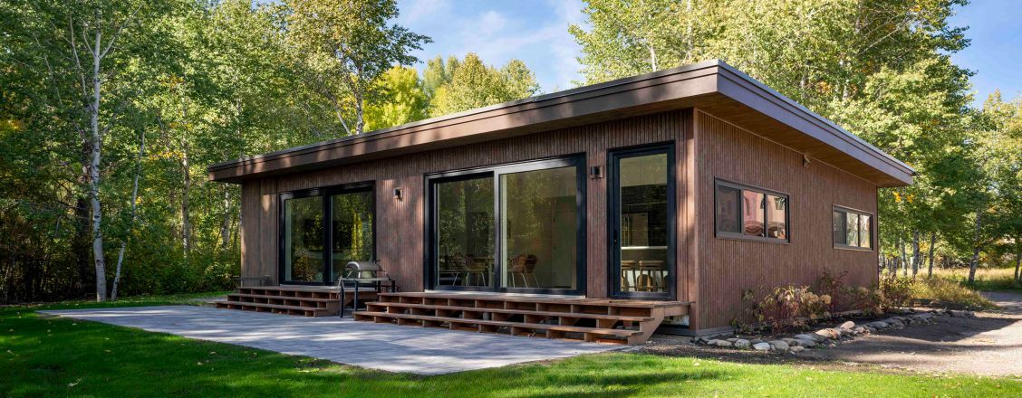 An 1189 sq. ft. residence located in Sun Valley, Idaho. Local building codes mandated higher energy efficiency, requiring structural insulated panel systems and triple-pane glazing to provide the additional roof and wall insulation. Courtesy of Built Prefab.