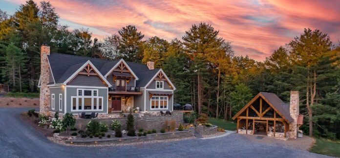 The home is grounded in its mountain setting by a mix of exterior materials including timbers, lap siding, shakes and stone. Timbers are made of kiln-dried, engineered white pine. Photo credit: Brett Hosterman
