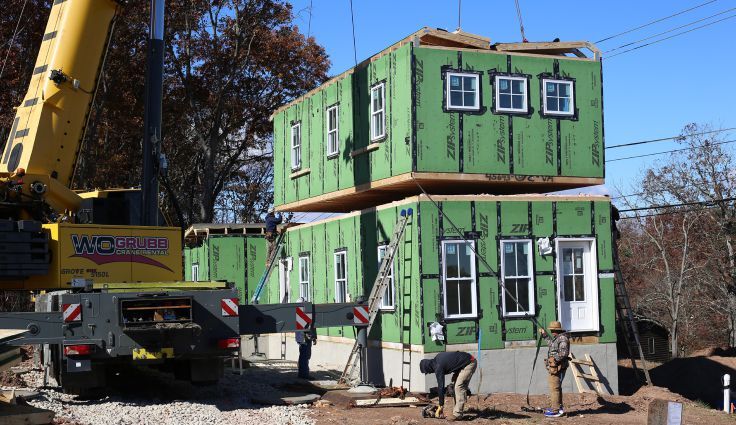 Installation of homes at the Stroubles Ridge development Image courtesy of Community Housing Partners
