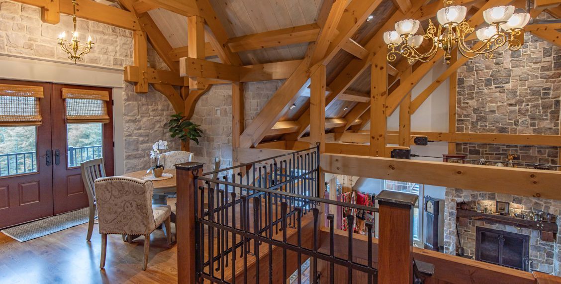 Timber beams and trusses, shown here in the loft, were fabricated in theTimberhaven shop, then numbered and lettered for efficient installation on-site. Photo credit: Brett Hosterman