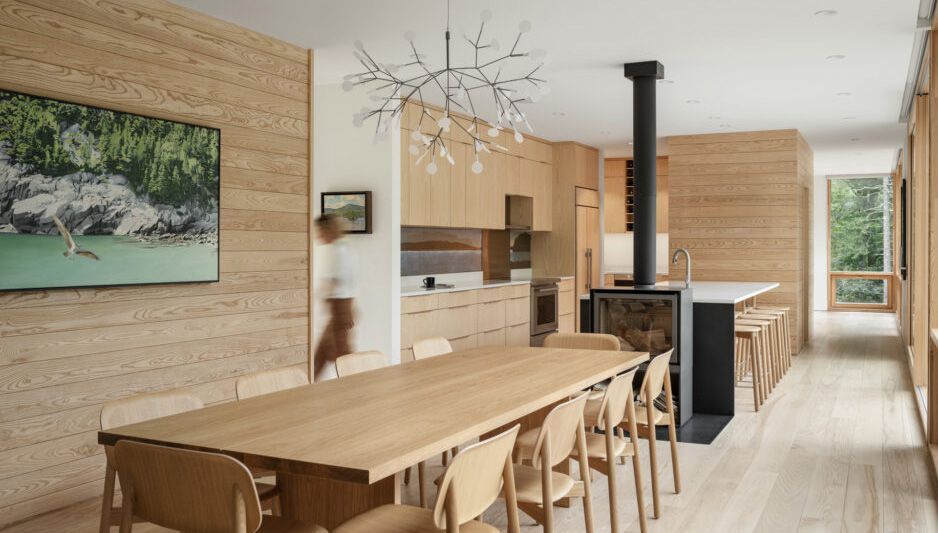 The Roost features large expanses of glass that allow living spaces to feel like they’re part of the surrounding woods. Photo by Trent Bell Photography