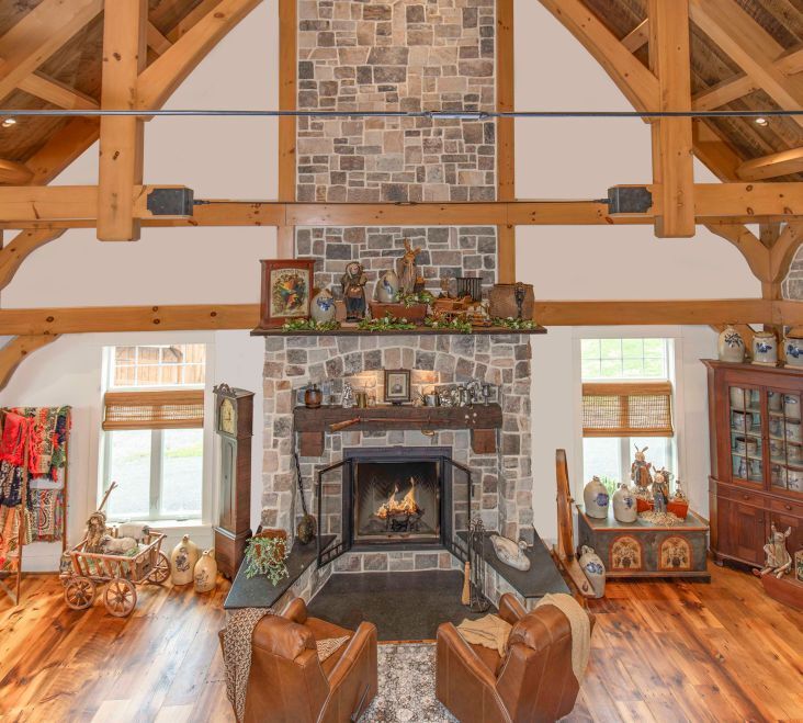 The great-room fireplace soars two stories through heavy timber trusses. Due to their sheer size, tie rods had to be used to support the trusses. Photo credit: Brett Hosterman
