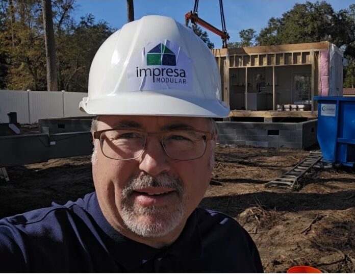 Morris on set day in front of a new modular home in Barnstable, Mass.