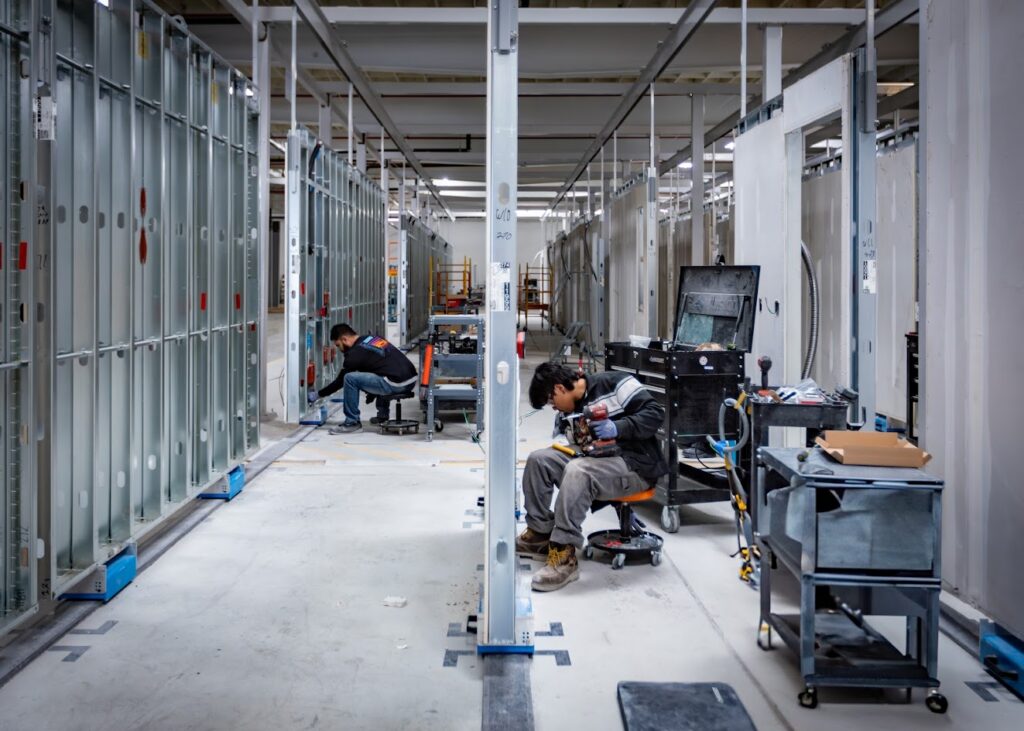 Inside the Model/Z factory in Los Angeles, California. The company decided to manufacture with steel rather than wood because of its durability and greater resistance to fire and other damage. 
Credit: Roxana Herrera, SoLa Impact
