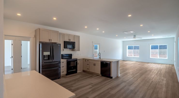 Finished interior of a completed Fading West home, featuring open floor plans, quartz countertops and quality finishes. Photo credit: Fading West