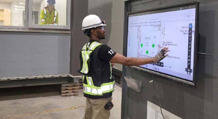 A QC inspector performing dimensional checks in the Modus facility image courtesy of Modus Structures.