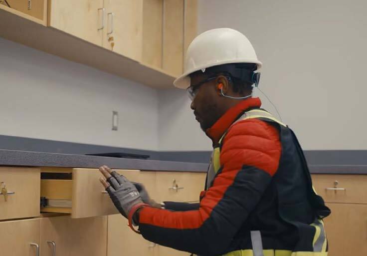 A QC inspector checking a drawer for fit and operation image courtesy of Modus Structures.