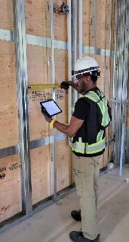 A QC inspector performing dimensional checks in the Modus facility image courtesy of Modus Structures.