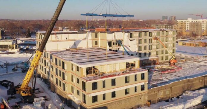 Setting modules at the 244,000 sq. ft. Eddi apartments in Edina, Minnesota. There are 203 market-rate apartments and 205 modular boxes. Photo credit: ProSet Modular