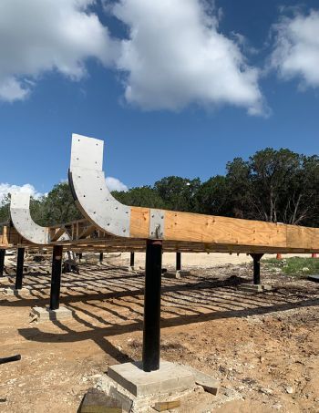 24” drilled piers with steel pipe and stainless-steel saddles support beams 24” to 60” above the natural grade.  photo courtesy of G-pod
