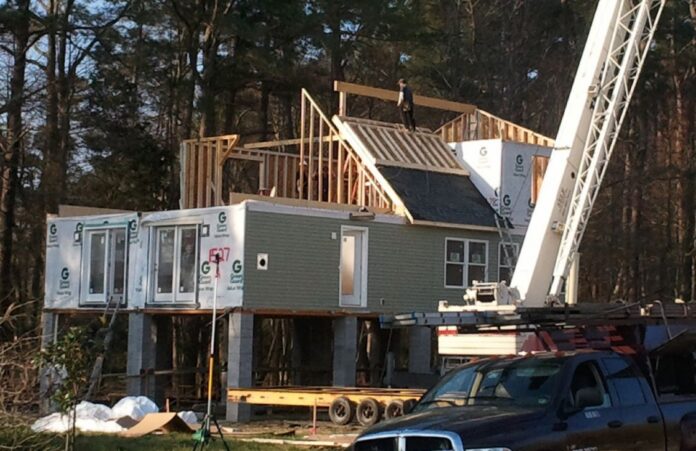 Modules cost the same whether they’re put on a standard foundation or on pilings. With this house, however, the second floor design was more economical to panelize than to build in a factory. Photo courtesy of Impresa Modular.