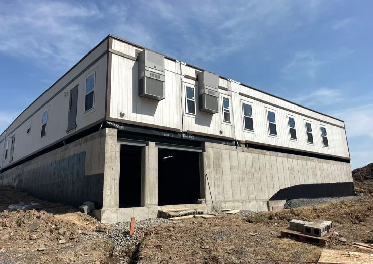 Located in Hancock, New York, this modular office space was installed over a basement constructed to accommodate a commercial bakery. Timna worked on this project, which required careful foundation planning, precise module placement and coordination of structural and MEP systems. Credit: Interstate Modular Structures
